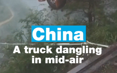 China: Truck with driver inside dangling in mid-air